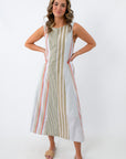 Front view of woman in striped midi dress with hands on hips