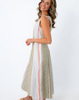 Woman in striped midi dress with side zipper and blue earrings