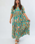 Sea Foam Green Mahi Maxi Dress with v neckline, ruffle collar, and colorful leaf pattern, perfect for weddings or casual summer events.