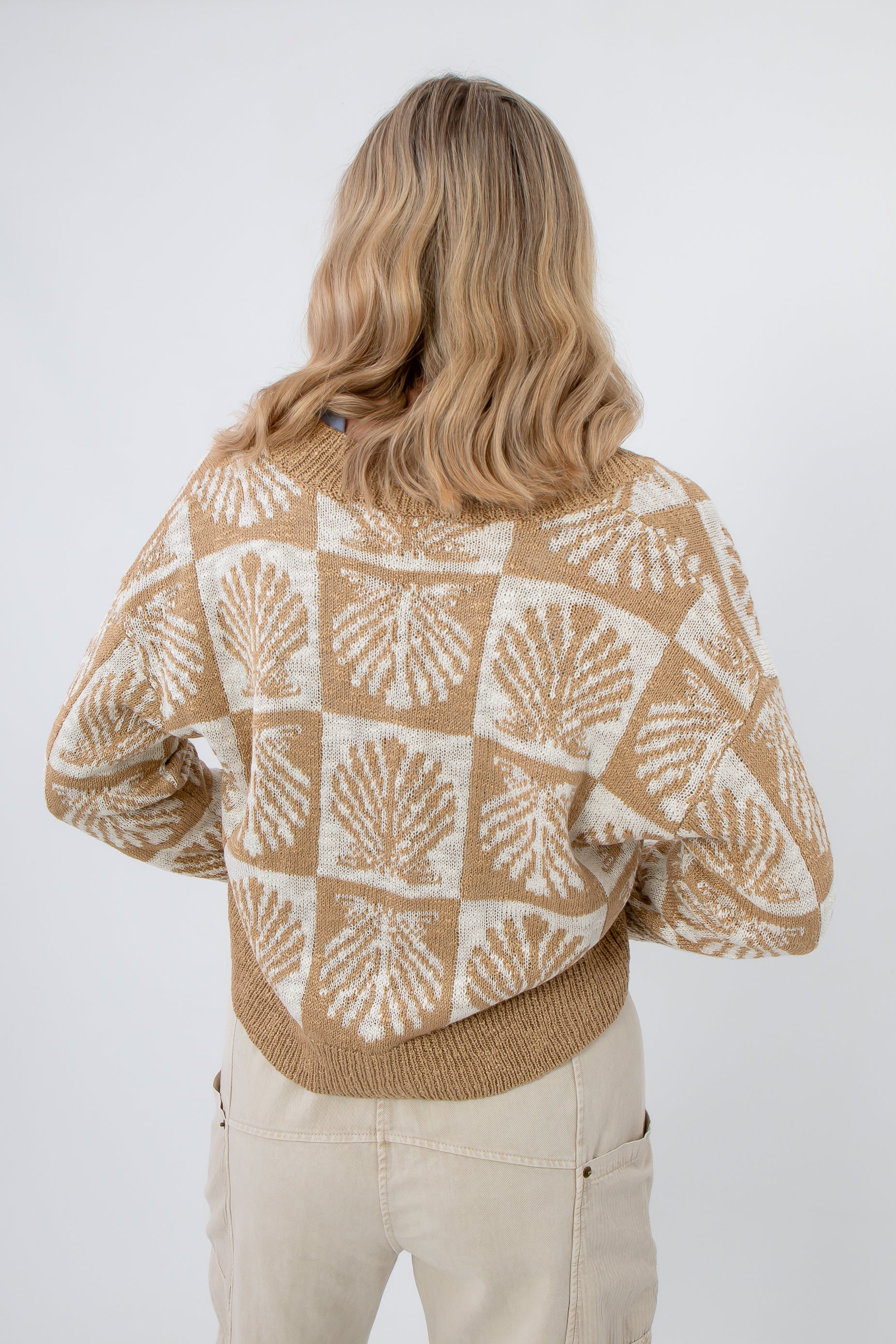 Back view of Cowrie Cutie Seashell Cardigan featuring all-over ivory seashell design on taupe knit, ideal for spring and summer outfits.