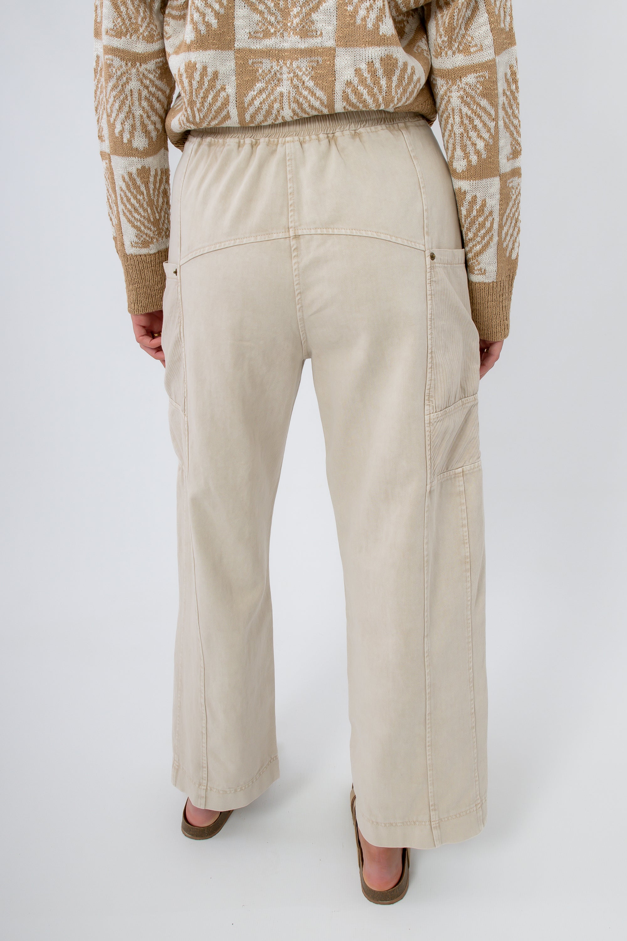 Back view of Breezy Natural Linen Cargo Pocket Pants showing elastic waistband and roomy fit, ideal for travel and everyday wear.