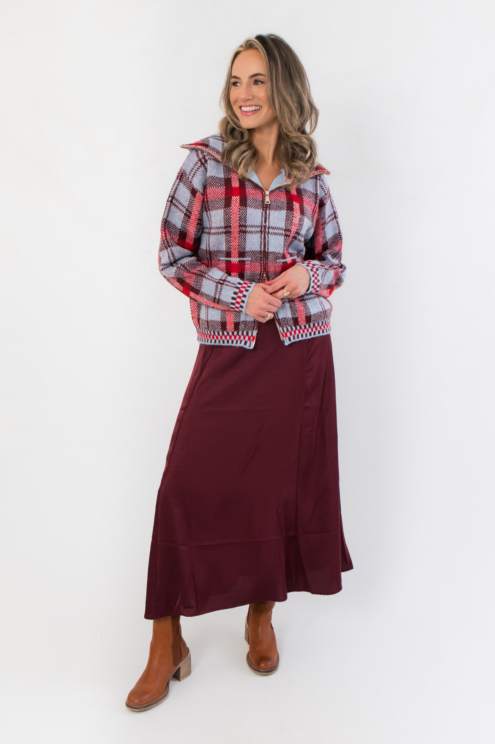 Luxe high-rise Z Supply Merlot Northpointe Satin Midi Skirt paired with a cozy plaid zip-up jacket, perfect for holiday and winter fashion.