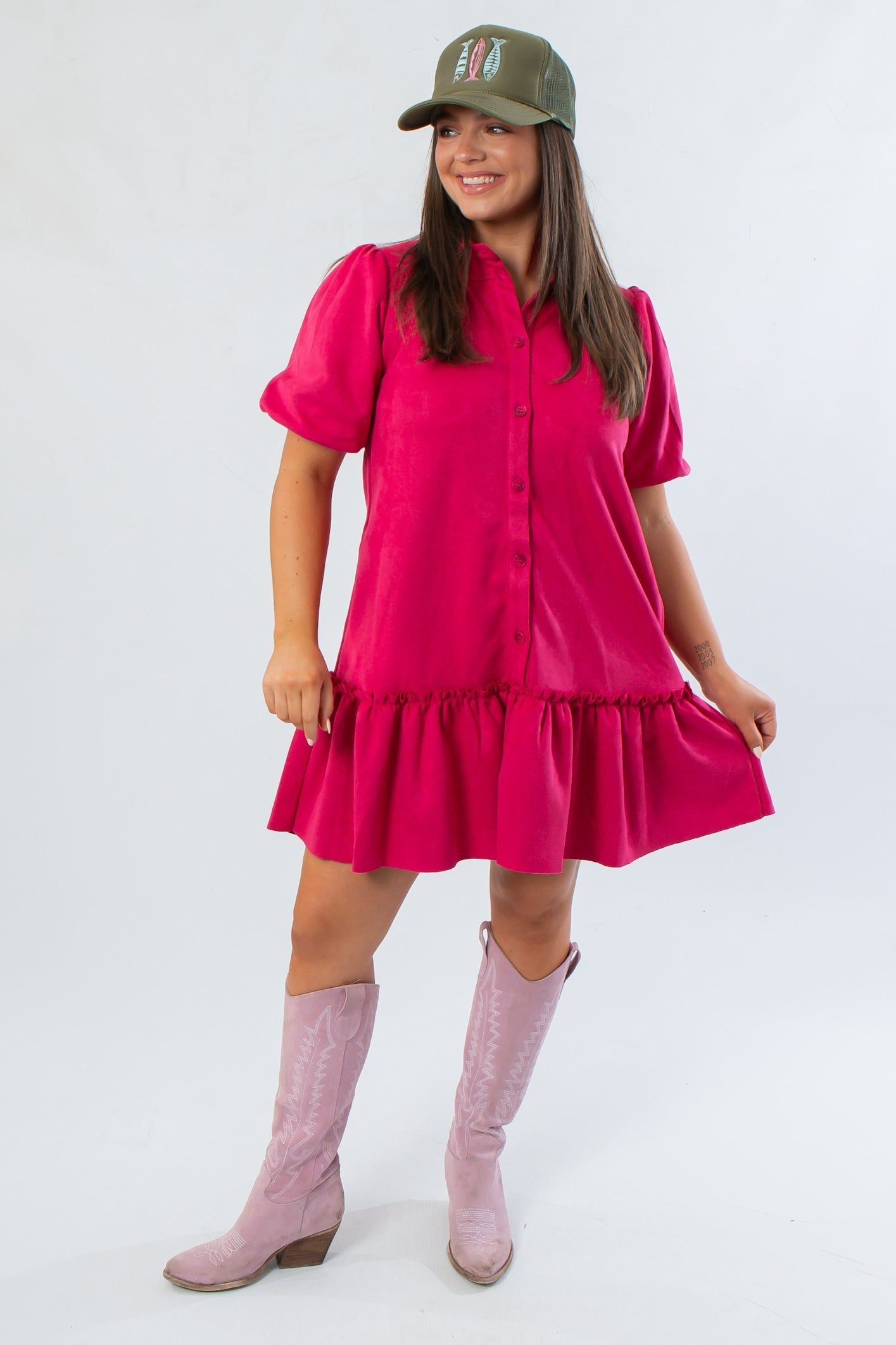 Berry Suede Puff Sleeve Mini Dress with collared neckline and ruffled hem, styled for fall with pink boots and a green cap.