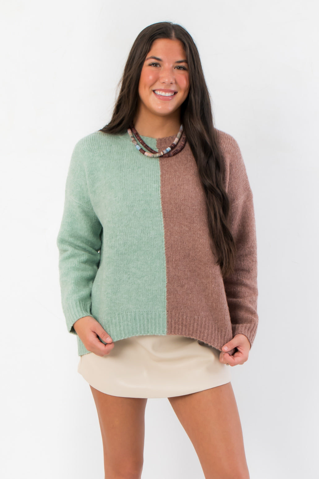 Road Ahead Mint & Brown Colorblock Sweater with oversized fit and crew neck, styled with a beige mini skirt for cozy fall fashion.