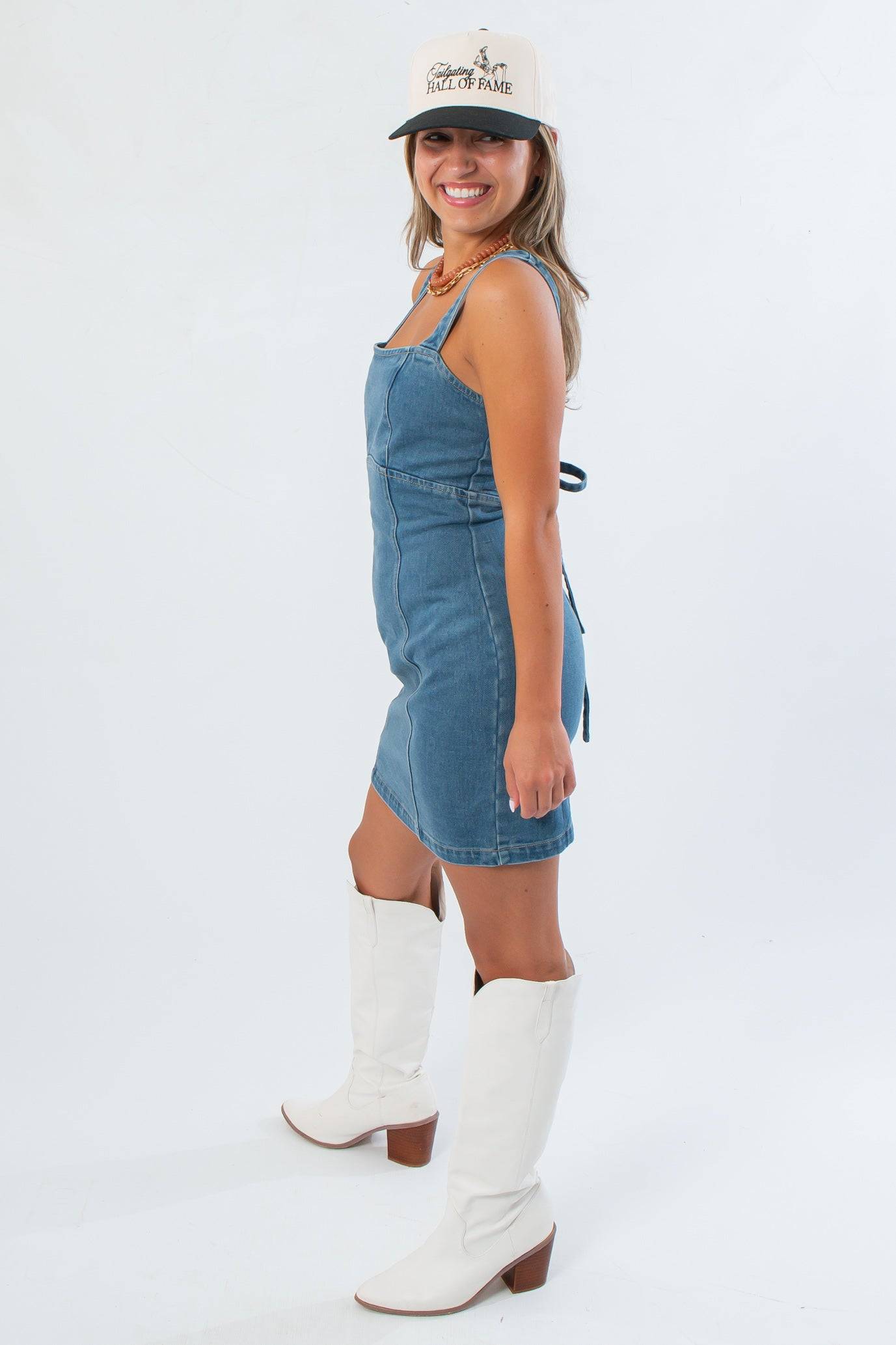 Side view of Karli Denim Corset Back Mini Dress highlighting its flattering fitted silhouette and casual gameday appeal.