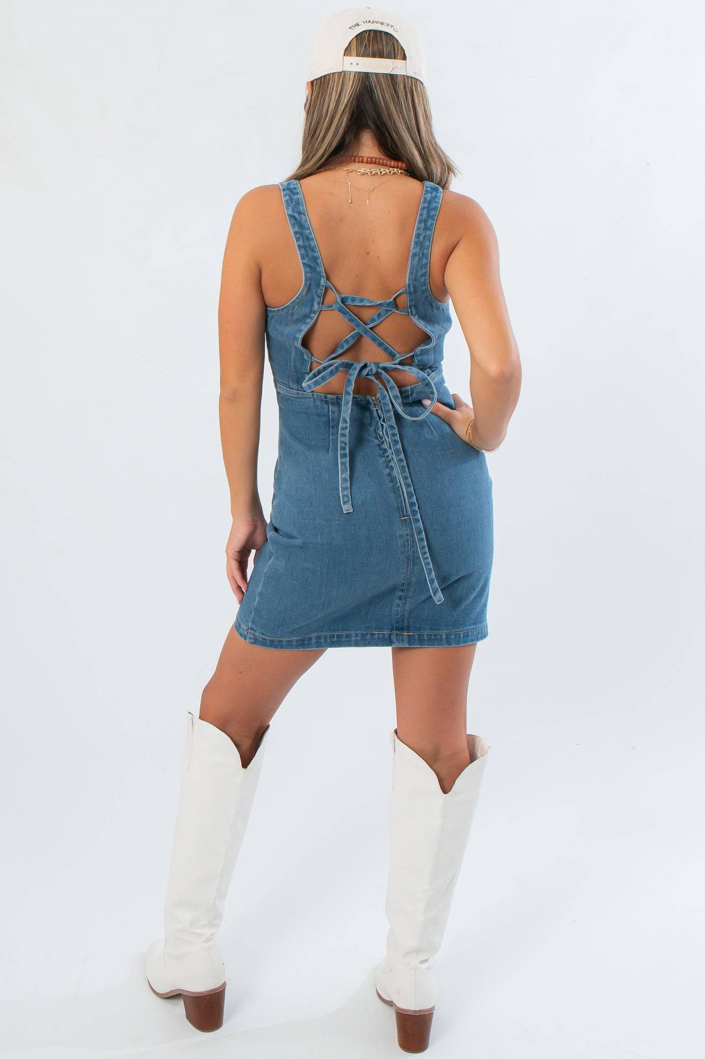 Back view of Karli Denim Corset Back Mini Dress featuring adjustable lace-up corset detail for a custom fit and stylish finish.
