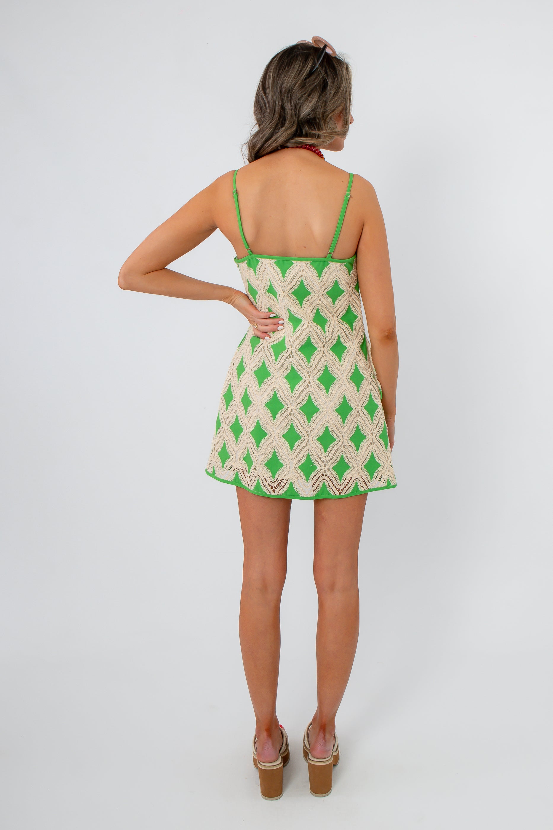 Back view of Regatta Green Crochet Diamond Mini Dress with adjustable straps and flared hem, styled for warm-weather outings.