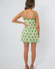 Back view of Regatta Green Crochet Diamond Mini Dress with adjustable straps and flared hem, styled for warm-weather outings.