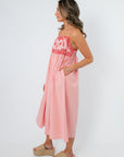 Side view of blush embroidered midi dress