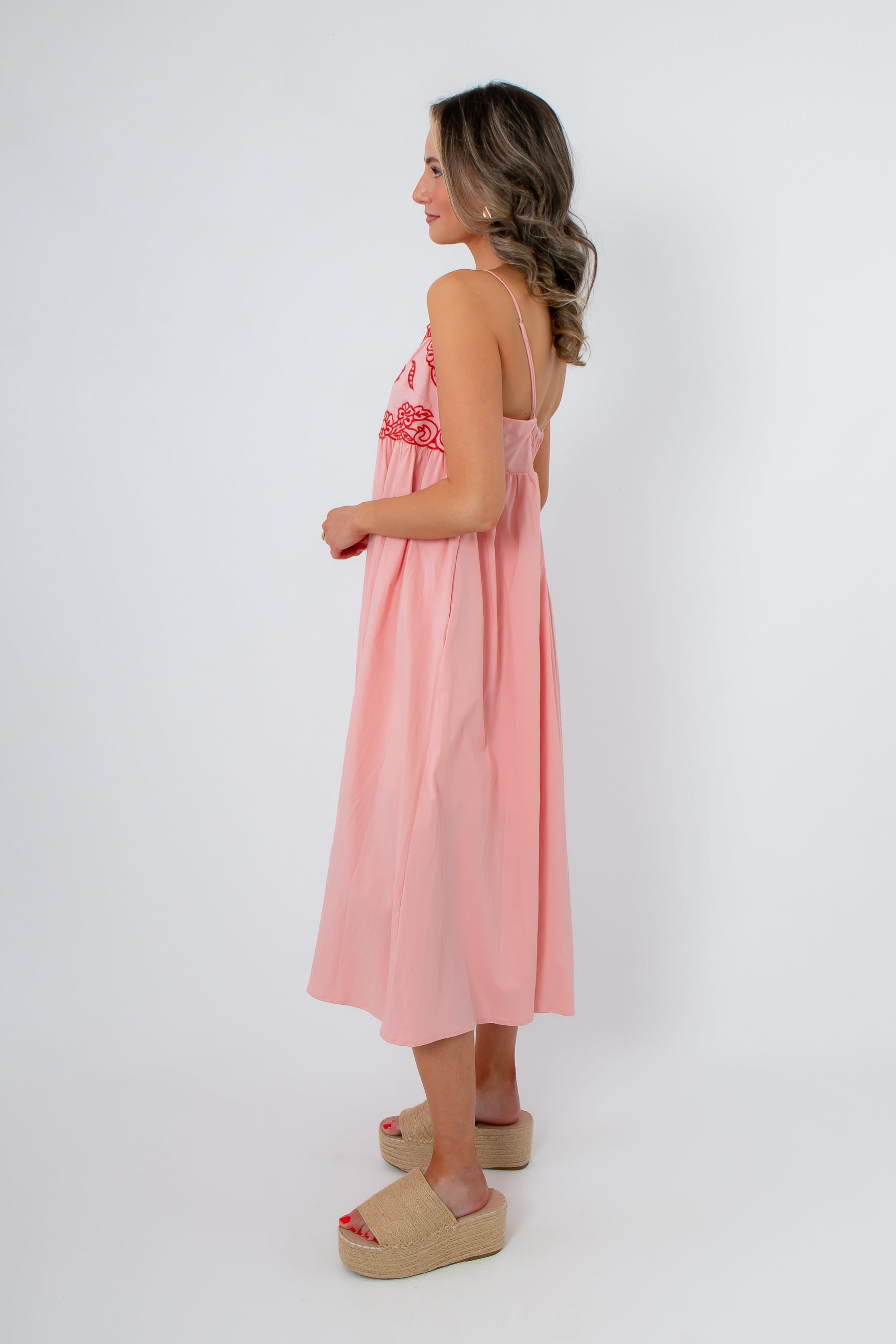 Back view of blush midi dress with pockets