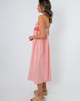 Back view of blush midi dress with pockets