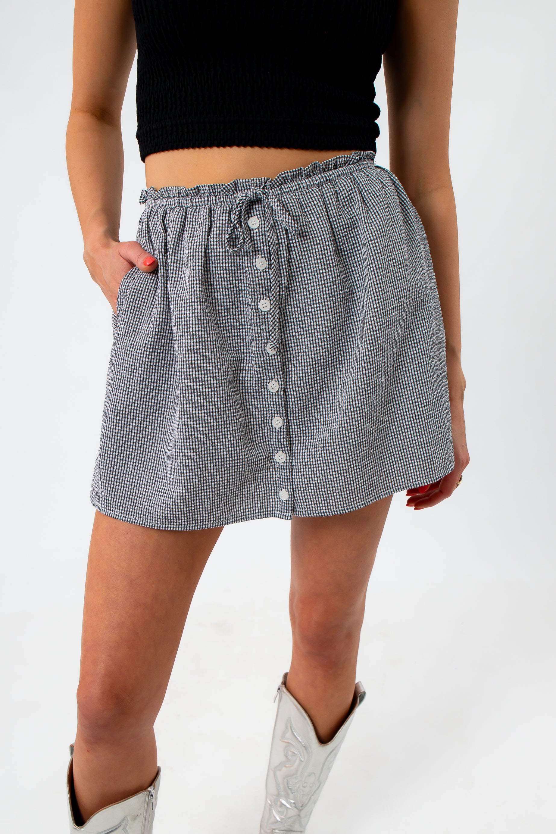 close-up of checkered mini skirt with button details