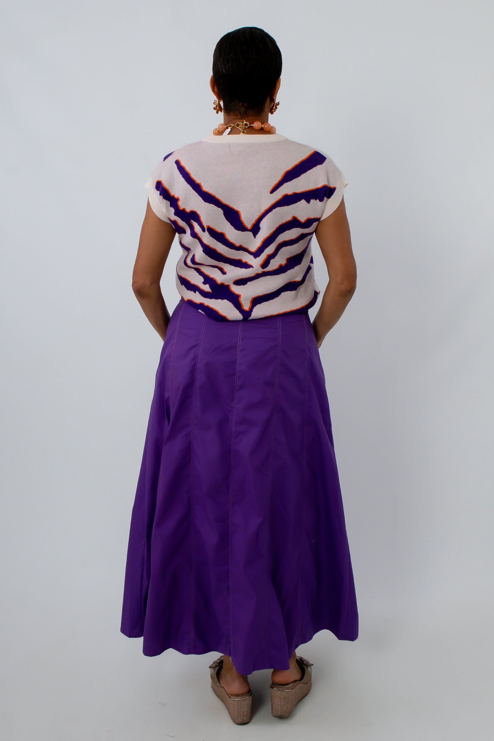 Paneled maxi skirt in deep purple with sleeveless sweater for a stylish game day look