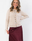 Juniper Multi Color Button Sweater – Beige ribbed cardigan with colorful buttons, self-tie bow at neckline, and front pockets for a cozy layered look.