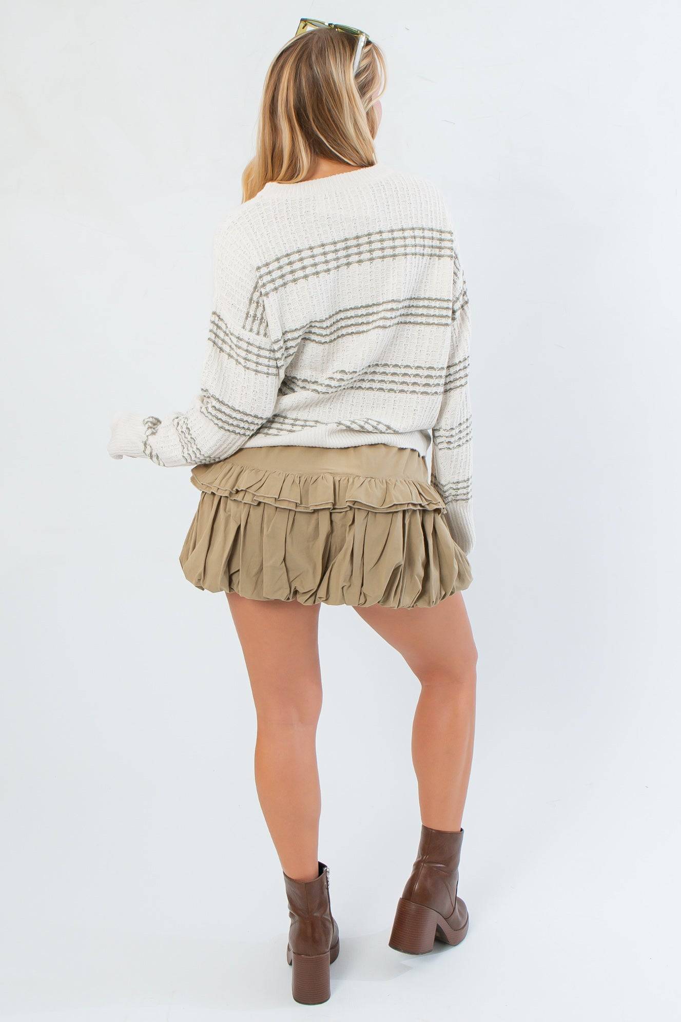 Back view of Paige Olive Stripe Textured Sweater highlighting its oversized fit and horizontal olive stripe pattern, ideal for fall outfits.