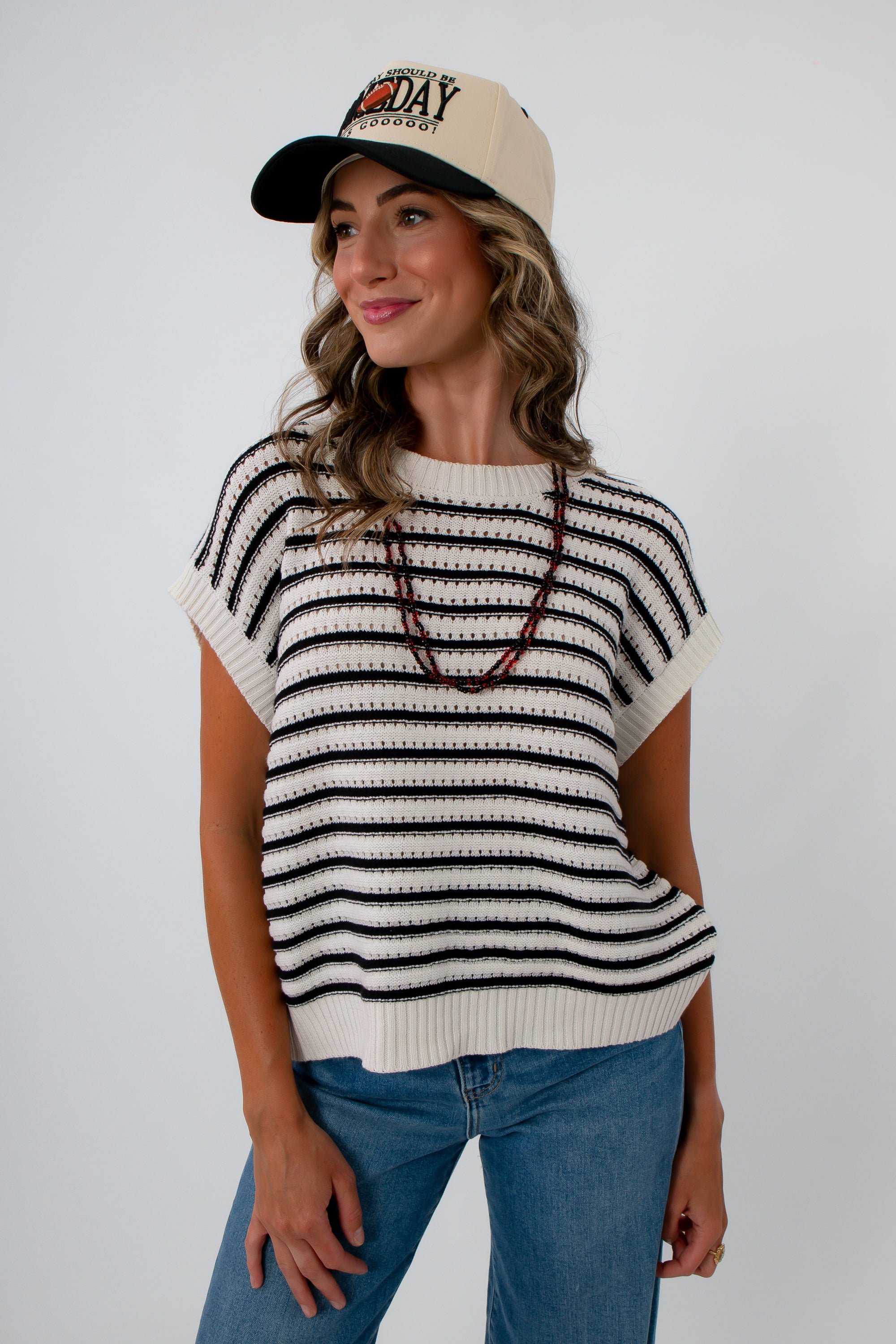 Black and White striped sleeveless sweater for neutral fall game day outfit