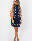 Penny Lane Navy Jacquard Sweater Dress with floral front design, mock neckline, and flared sleeves, ideal for cozy fall fashion.