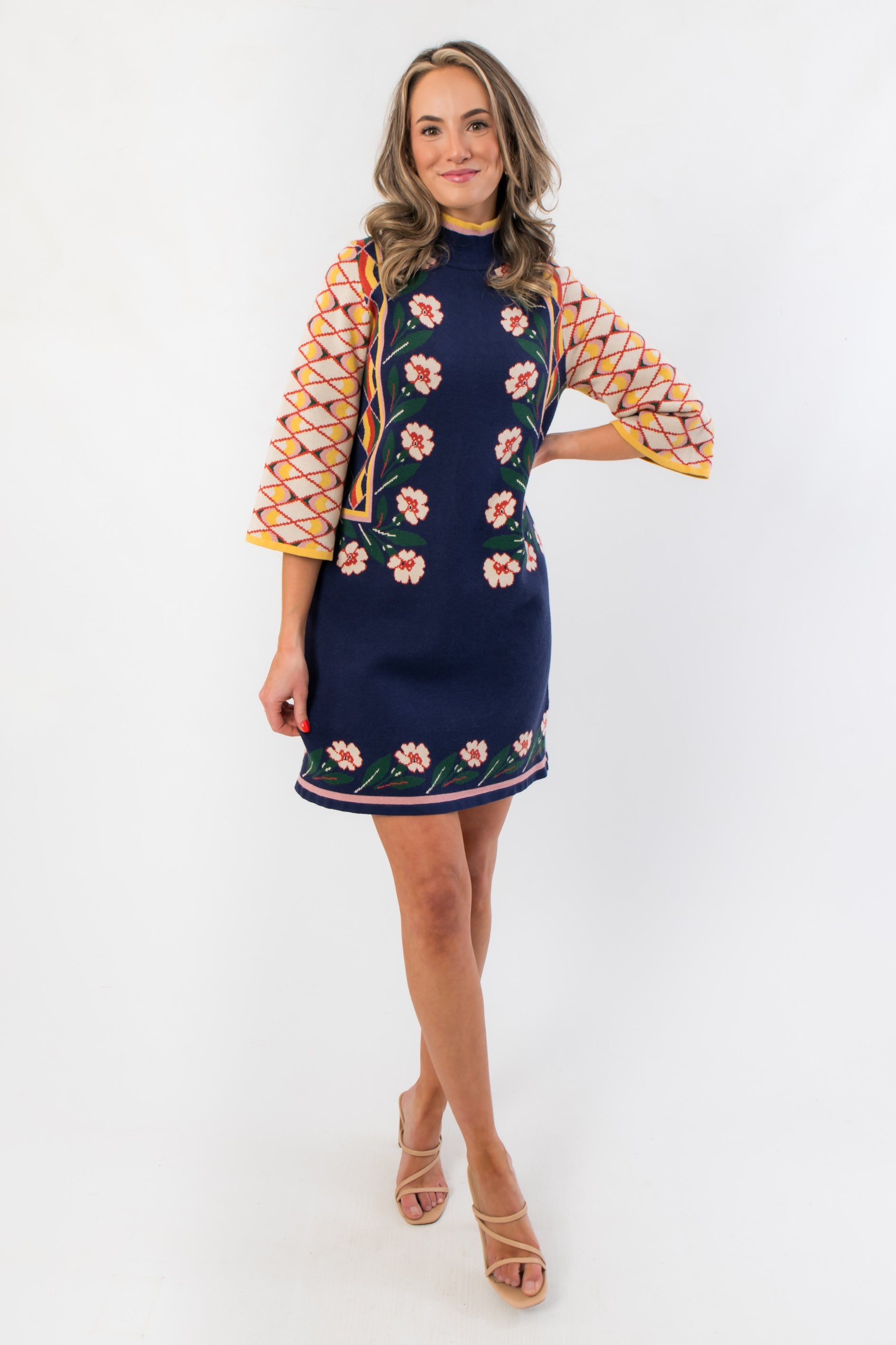 Elegant Penny Lane Navy Jacquard Sweater Dress featuring colorful jacquard sleeves and a flattering short silhouette for casual autumn wear.