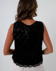 Black sequin top for dinner date, features a scalloped trim and all over sequins
