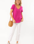 Stylish and comfortable Z Supply Magenta Asher V-Neck Tee paired with white denim and a woven bag, perfect for any season.