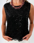 Black sequin top for dinner date with scallop trim and white mini skirt for game day look