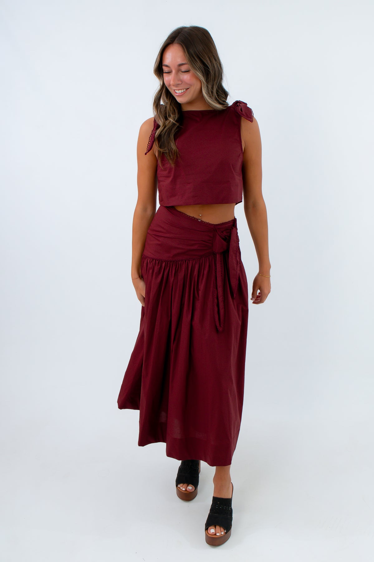 Women’s garnet-burgundy skirt set with boxy crop top, flattering skirt and intricate trim details