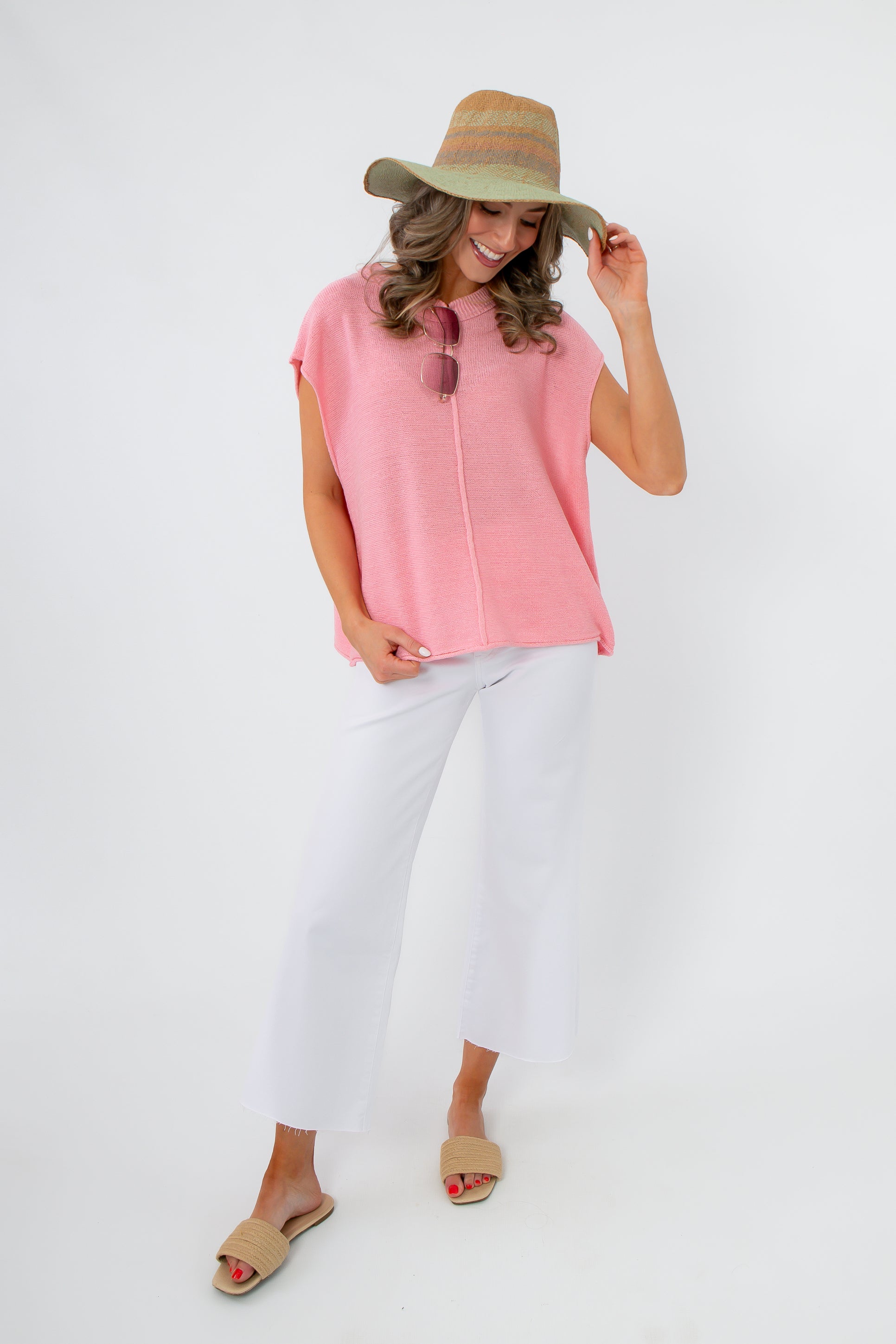 Frankie Pink Knit Sleeveless Sweater styled with white pants
