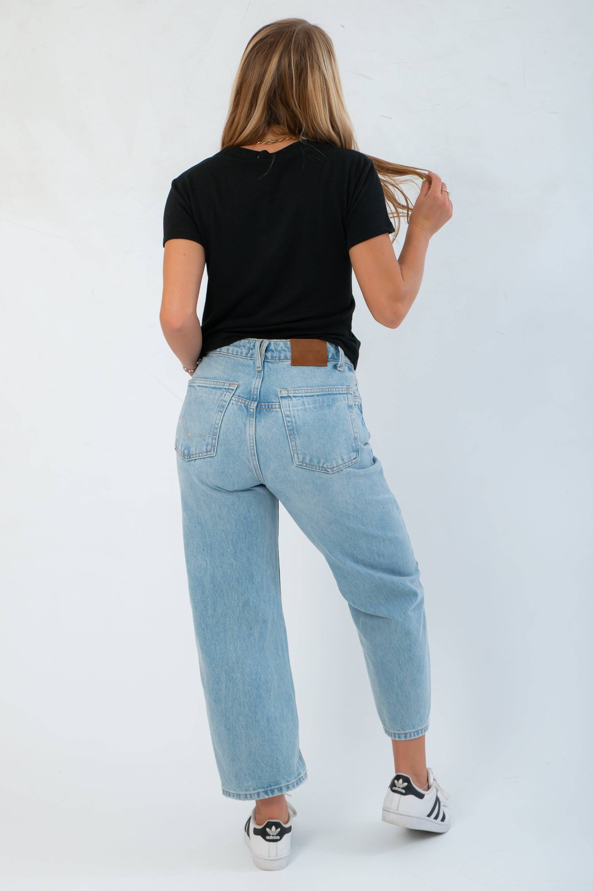 Z Supply Black Tourist Tee – Back view of relaxed fit cotton t-shirt, styled with high-rise light blue jeans and casual sneakers.