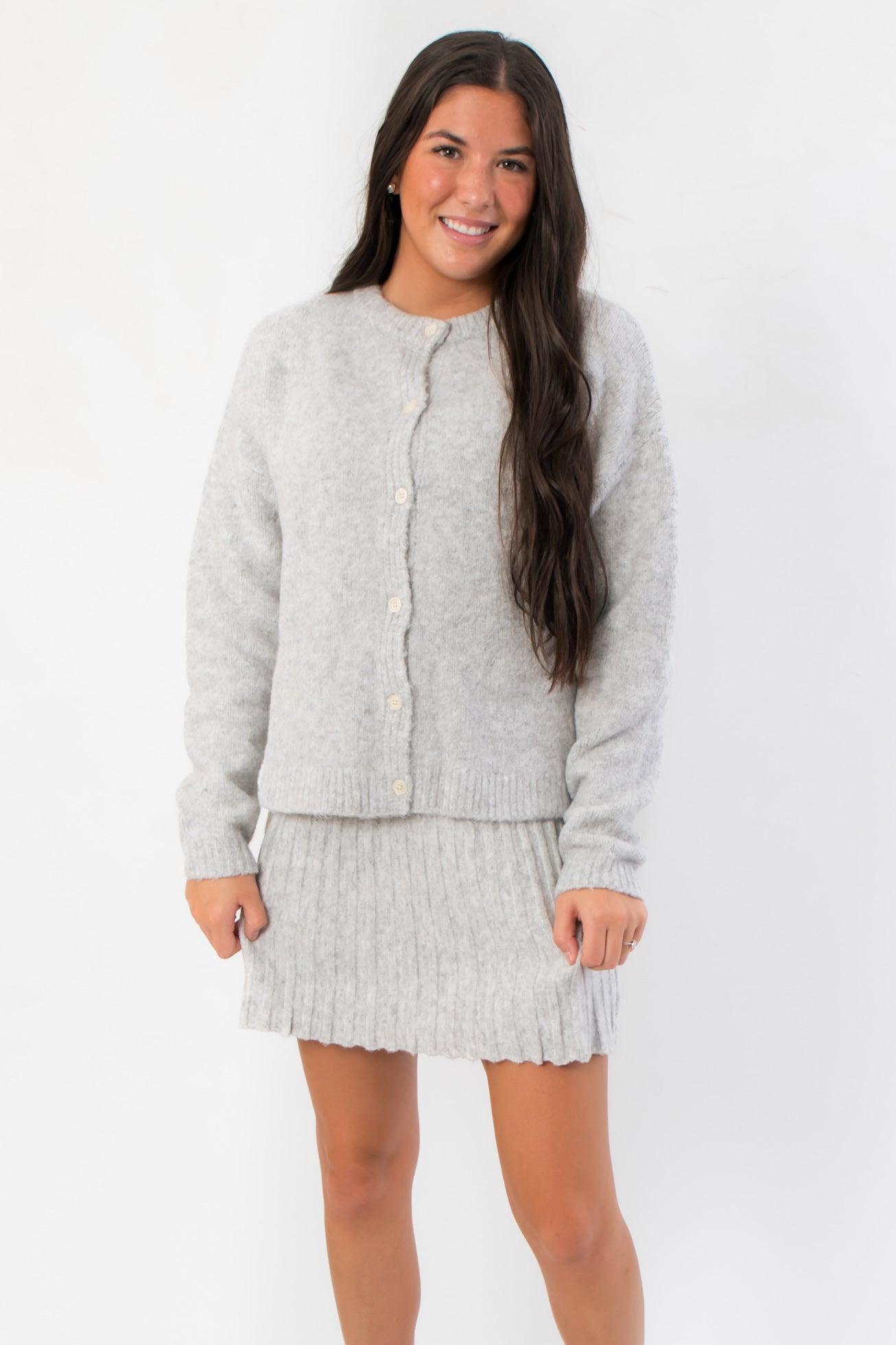 Livia Grey Button Up Sweater Skirt Set featuring cozy knit cardigan and ribbed mini skirt, ideal for casual or dressy winter outfits.