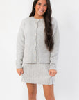 Livia Grey Button Up Sweater Skirt Set featuring cozy knit cardigan and ribbed mini skirt, ideal for casual or dressy winter outfits.