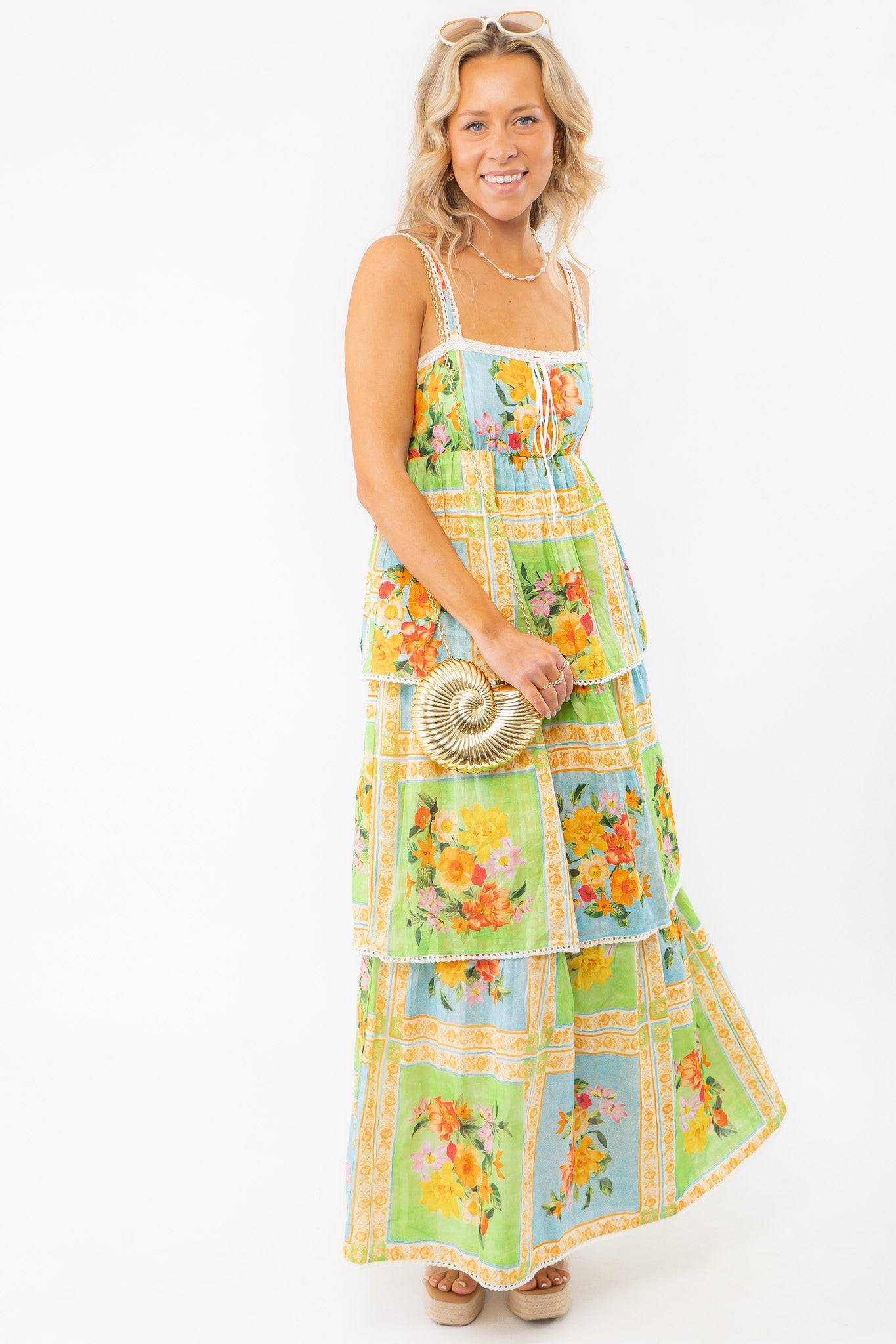 Elegant Show Me Your Mumu Peyton Country Bouquet Midi Dress with a tiered silhouette, smocked bodice, and floral print, ideal for warm-weather occasions.