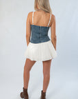 Back view of Show Me Your Mumu Denim Tiffany Skort Dress with zipper closure and flared cream skirt, a best-selling short dress for fall fashion.