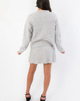 Back view of Livia Grey Button Up Sweater Skirt Set highlighting the soft knit fabric and flattering mini skirt silhouette.