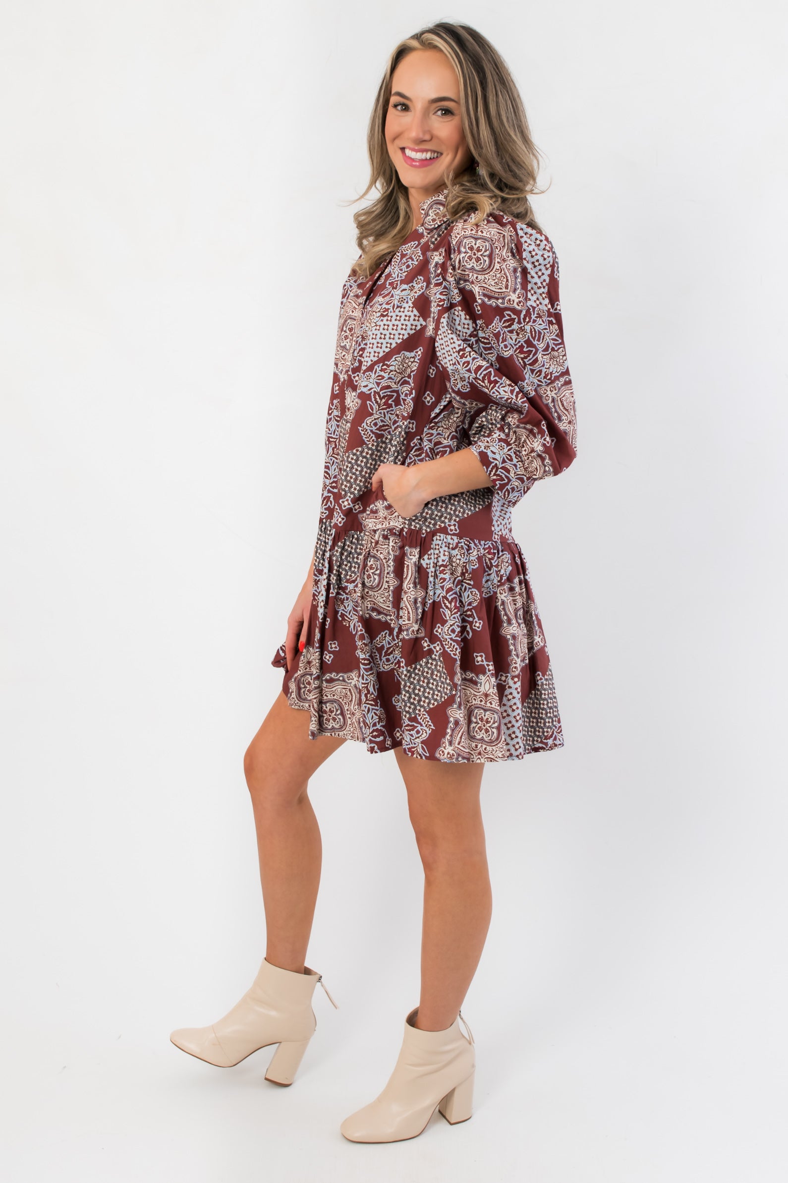 Side view of Scottie Burgundy Print Tiered Mini Dress showcasing flared skirt and relaxed fit, great for casual and patterned dress collections.