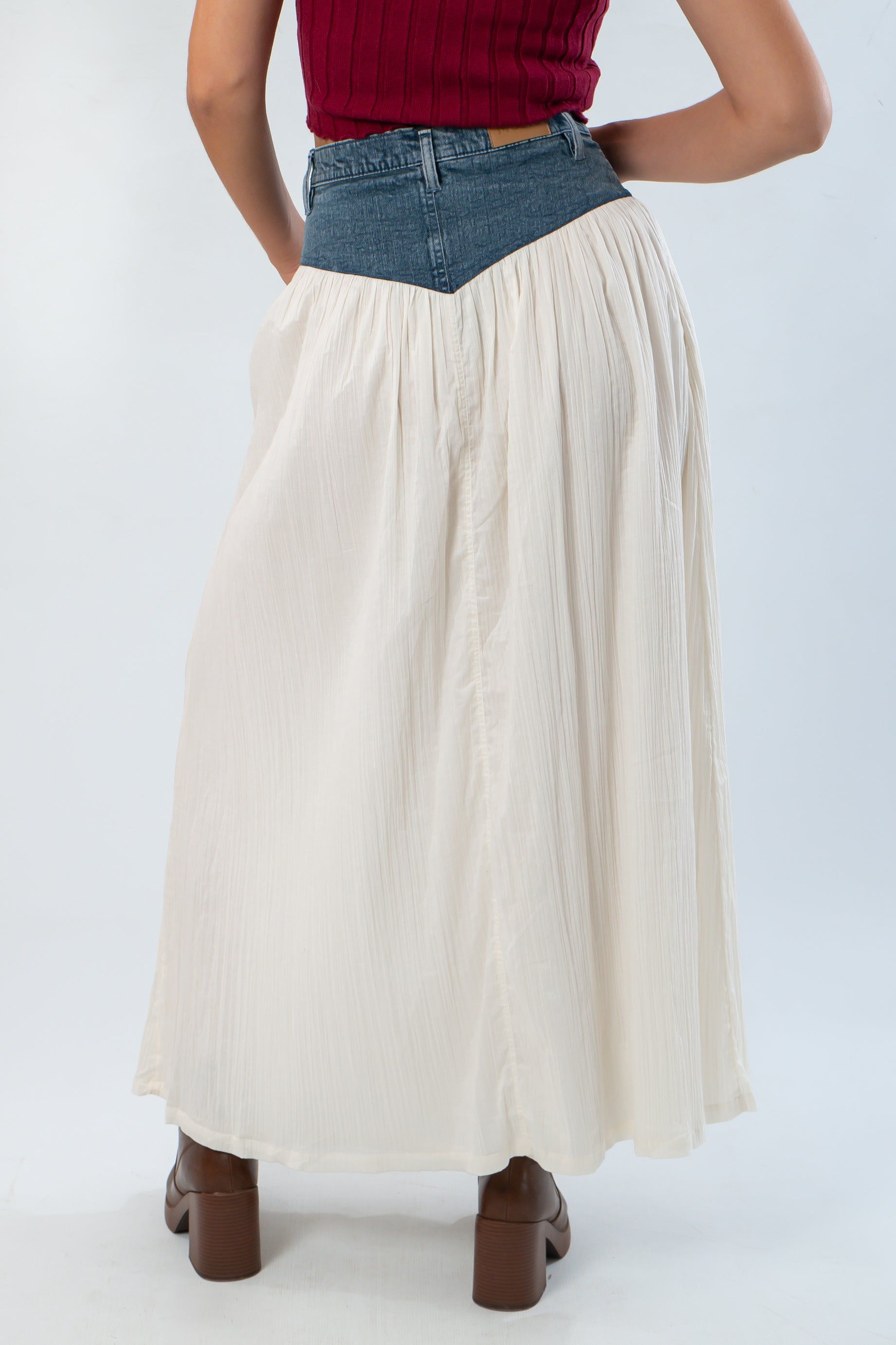 Back view of Show Me Your Mumu Denim Voile Maxi Skirt showing pleated cream fabric and V-shaped denim waistband detail.