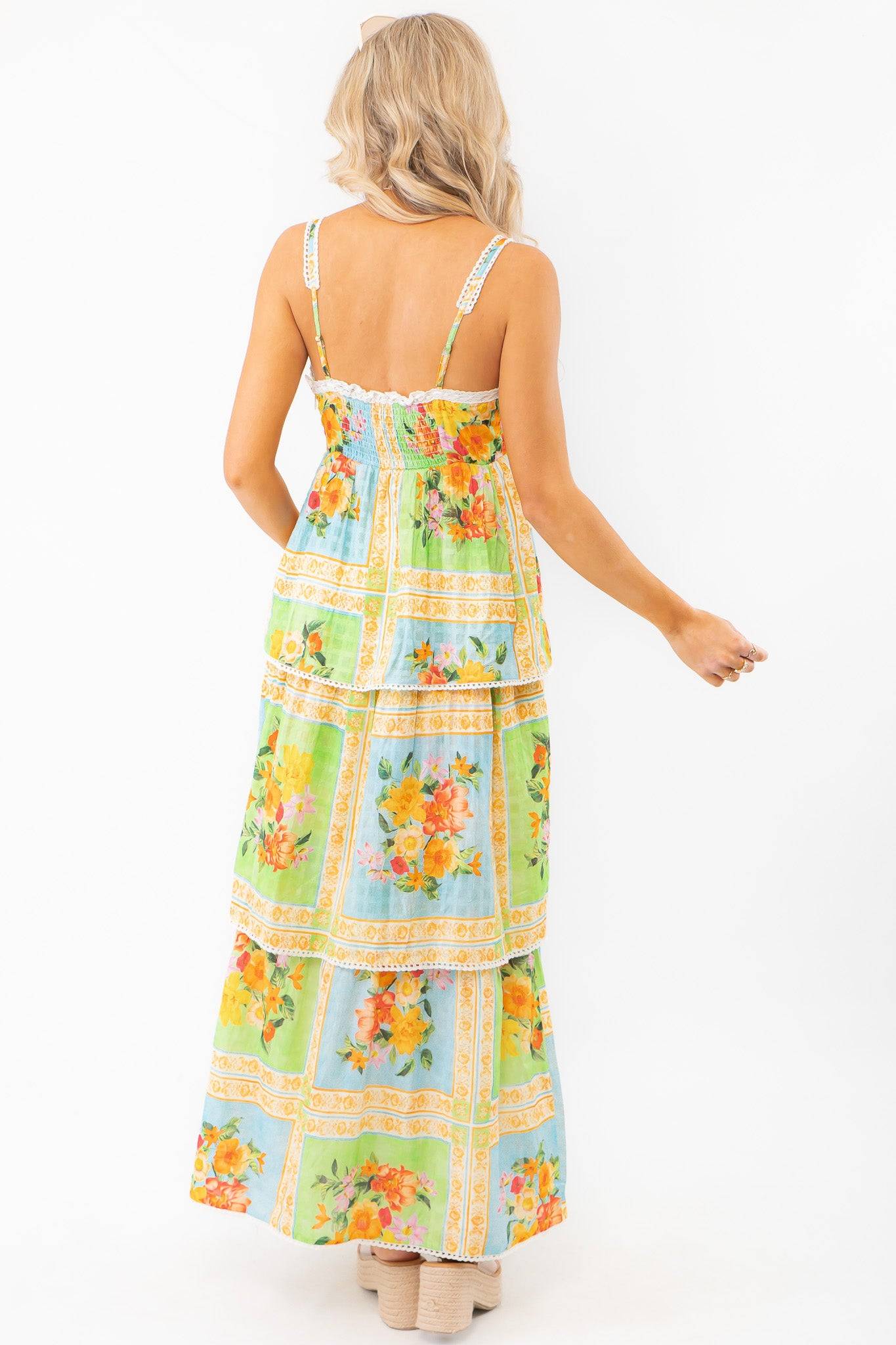 Back view of the Show Me Your Mumu Peyton Country Bouquet Midi Dress showcasing its smocked bodice, adjustable straps, and flowing floral skirt.