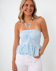 Light blue eyelet halter top with ruched bust and ruffled hem