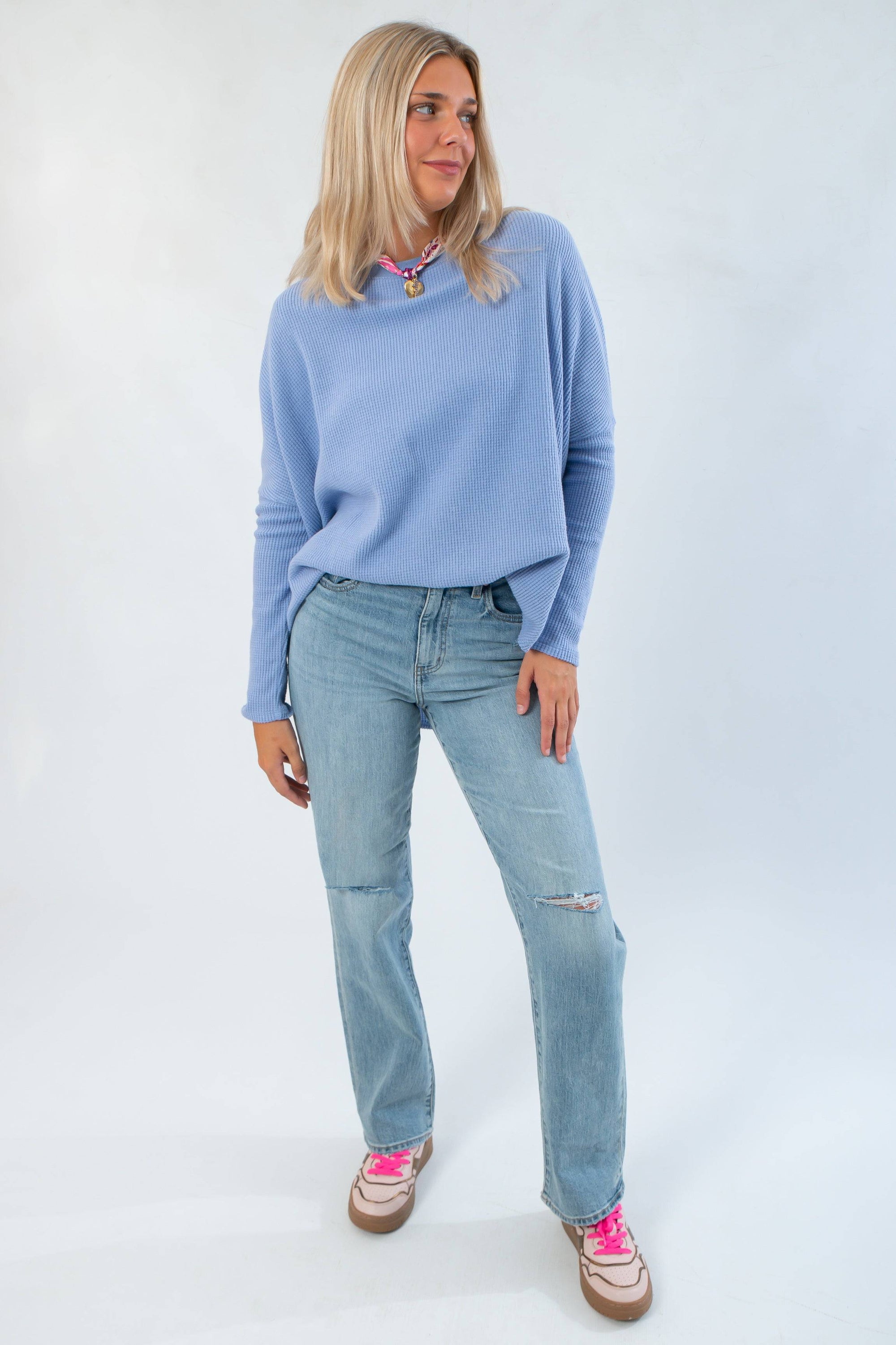 Free People Dawn Breeze Latte Blues Solid Thermal in oversized waffle knit with boat neckline, styled with light wash jeans for a cozy fall look.
