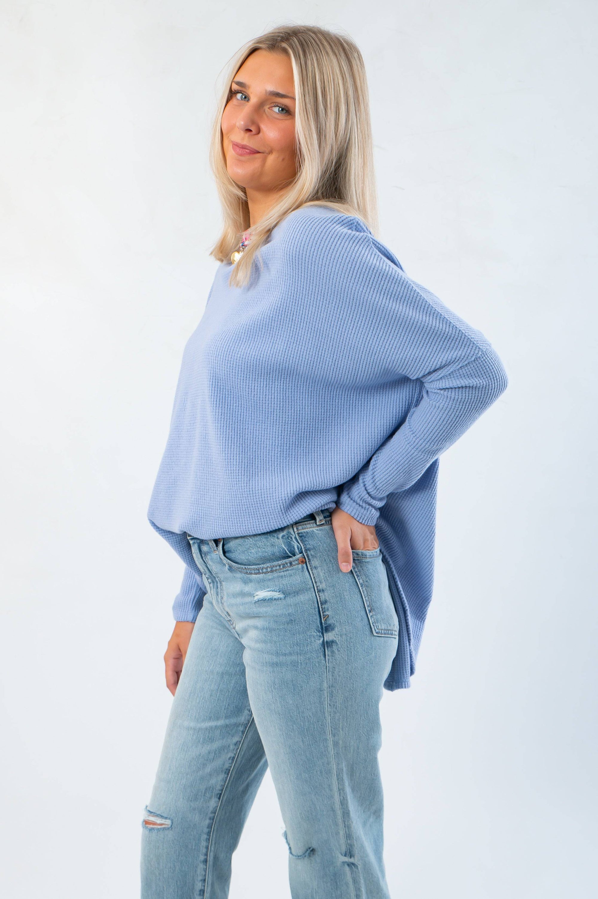 Side view of Free People Dawn Breeze Latte Blues Solid Thermal showing loose fit and curved hem, ideal for casual winter and fall outfits.