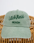Sunwashed Litchfield Beach embroidered baseball cap on wicker