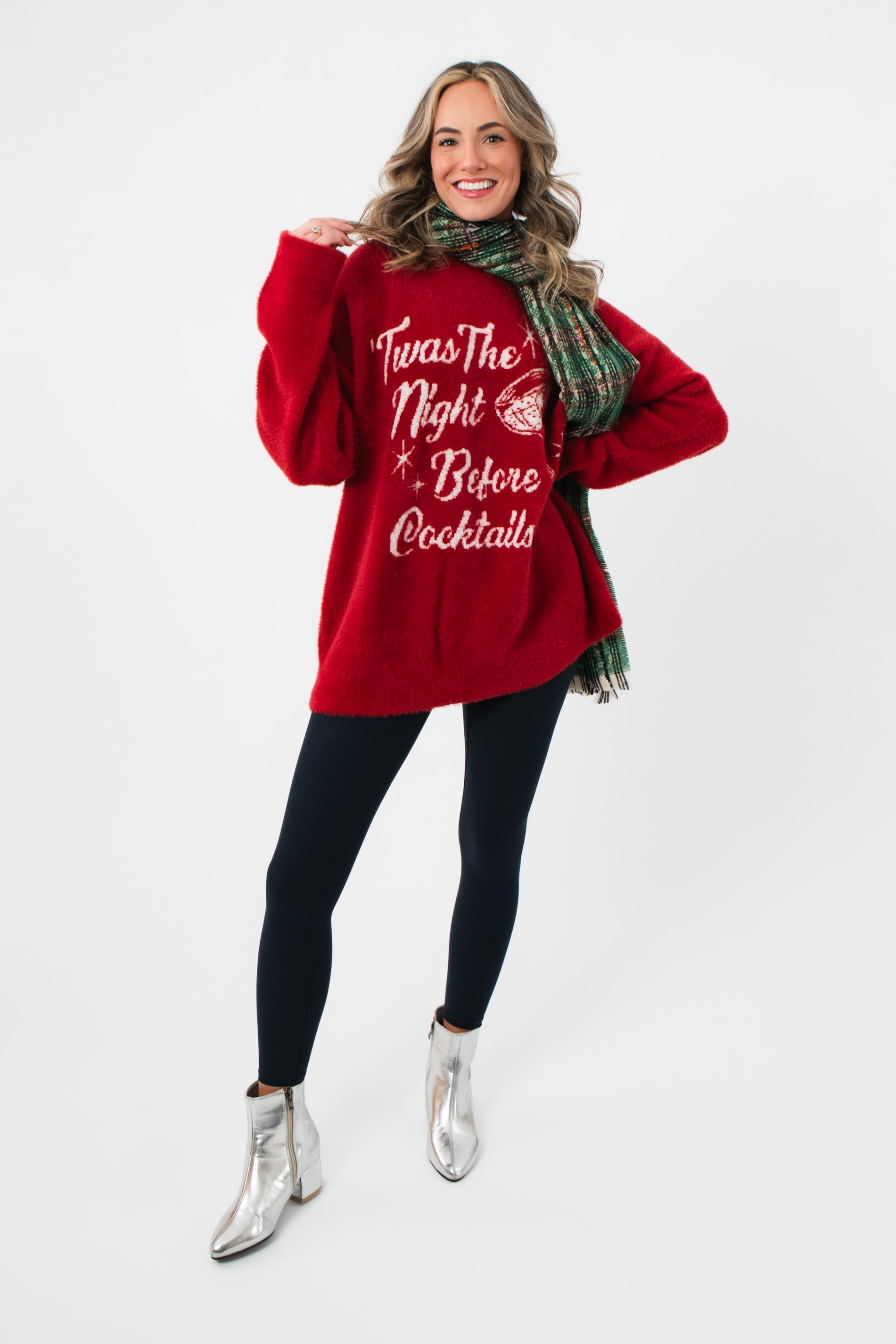 Festive red Show Me Your Mumu Twas The Night Knit Classic Crewneck Sweater paired with black leggings and silver boots for a cozy holiday look.