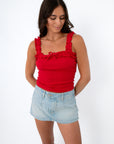 Red ruffled tank top with bow detail, front view