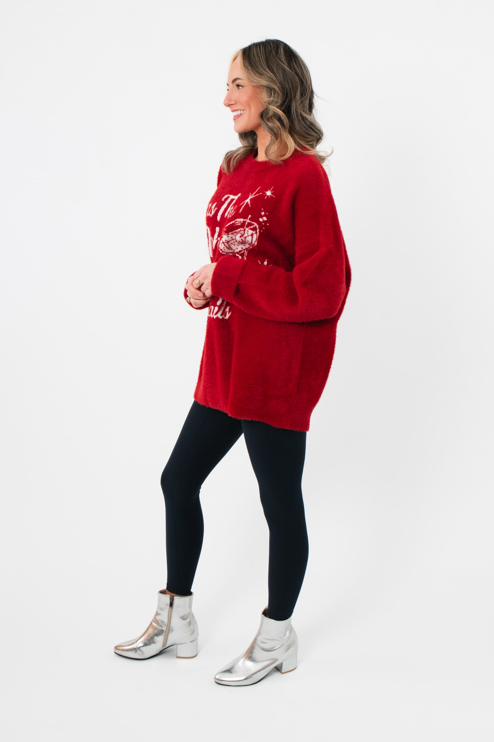 Side view of the Show Me Your Mumu Twas The Night Knit Classic Crewneck Sweater showing relaxed fit and soft knit texture in holiday red.