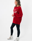 Side view of the Show Me Your Mumu Twas The Night Knit Classic Crewneck Sweater showing relaxed fit and soft knit texture in holiday red.