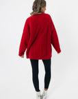Back view of the Show Me Your Mumu Twas The Night Knit Classic Crewneck Sweater highlighting its oversized cozy silhouette in plush red knit.