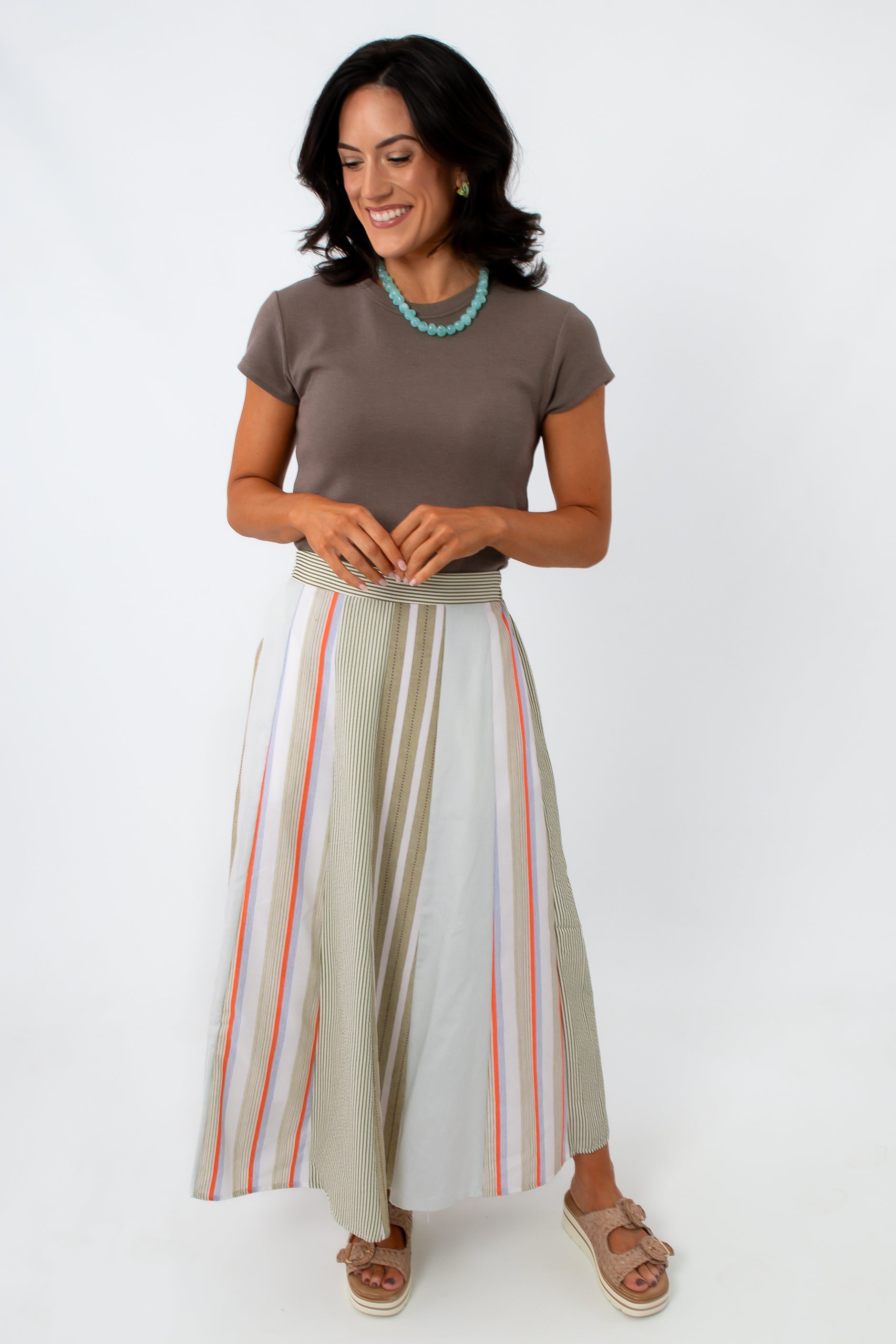woman wearing striped midi skirt with side pockets and elastic waistband