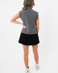 Back view of Rowan Grey Mockneck Sweater Tank displaying ribbed knit finish and sleeveless cut for versatile layering.