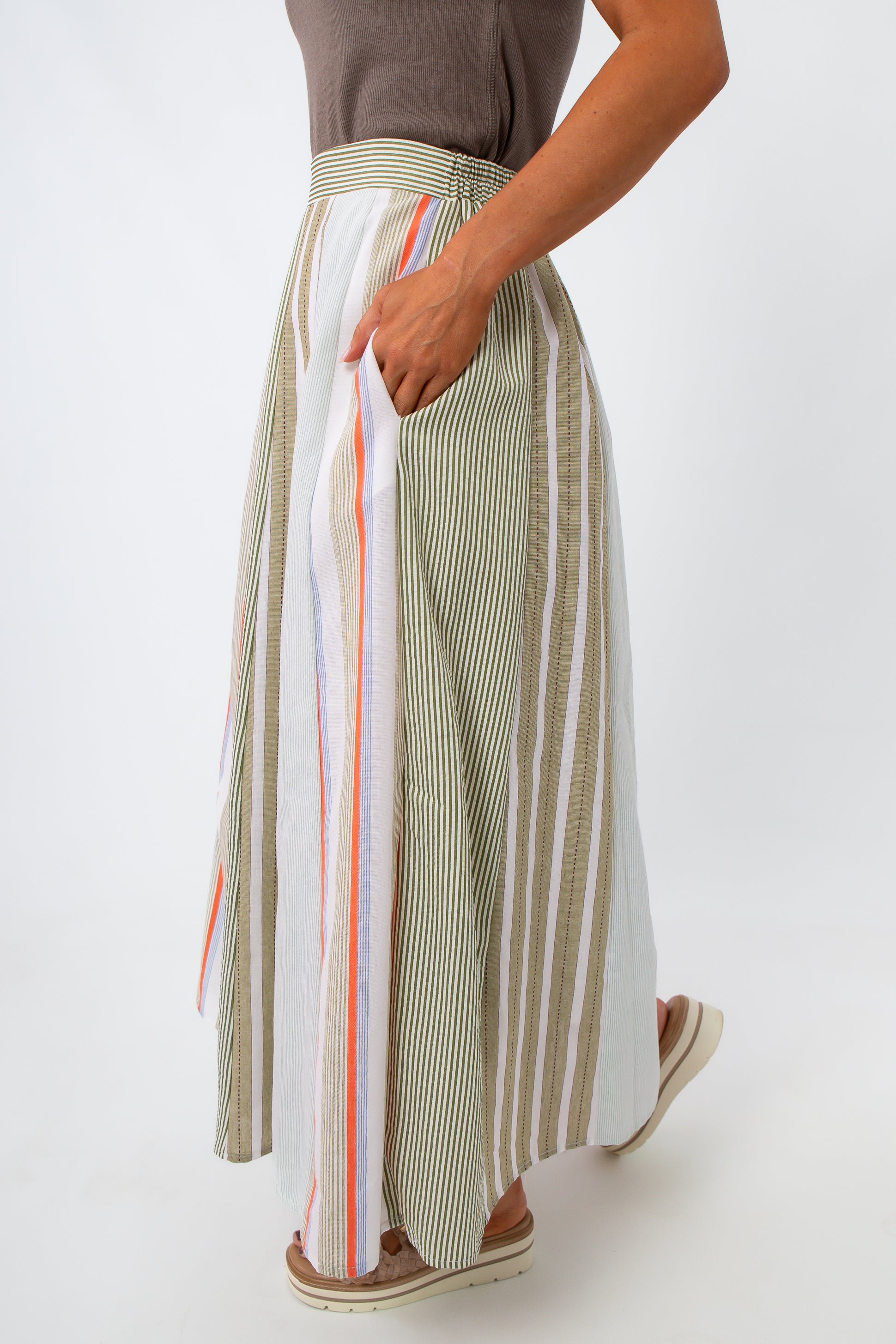 woman in striped midi skirt showing side pocket and elastic waistband
