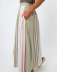 woman in striped midi skirt showing side pocket and elastic waistband