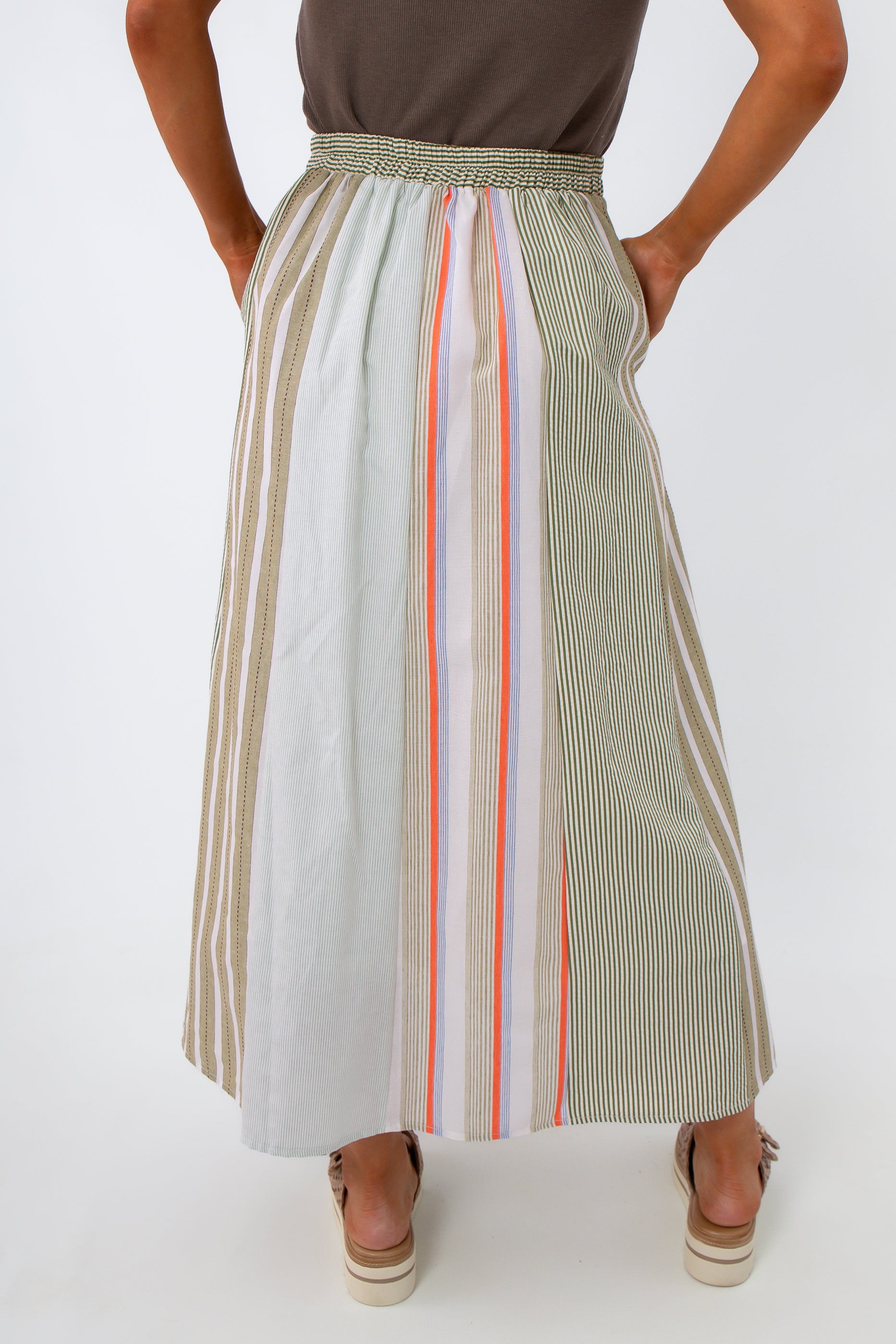full-length view of woman in striped midi skirt with beige platform sandals